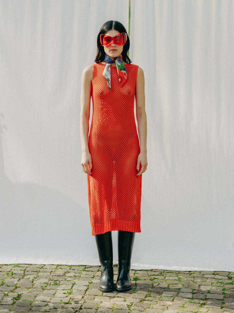 Elegant net knit dress crafted in Switzerland, featuring a classic round neckline, fitting armholes, and stylish side slits, made from organic cotton, perfect for evening wear or summer outings over swimwear.