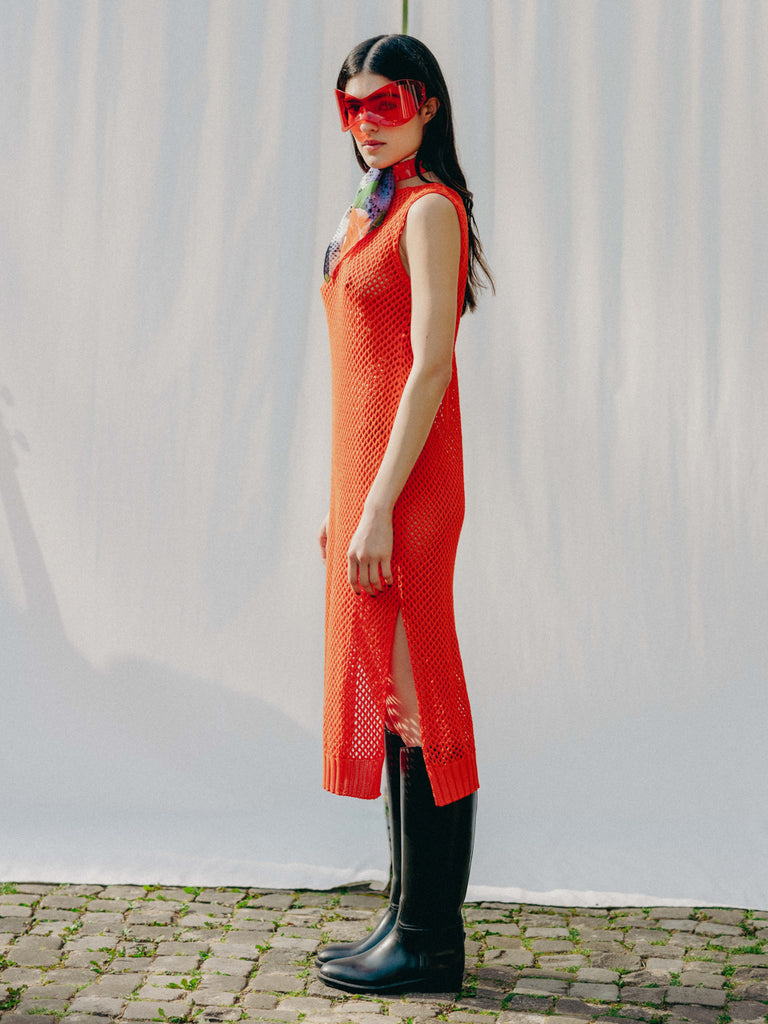 Elegant net knit dress crafted in Switzerland, featuring a classic round neckline, fitting armholes, and stylish side slits, made from organic cotton, perfect for evening wear or summer outings over swimwear.