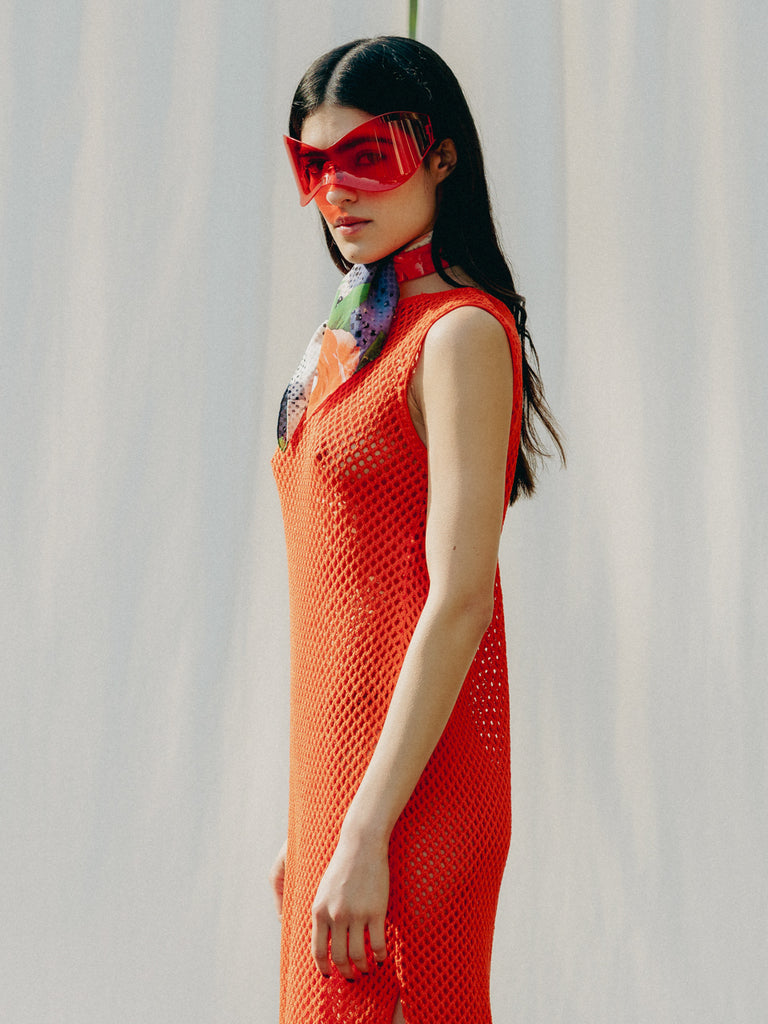 Elegant net knit dress crafted in Switzerland, featuring a classic round neckline, fitting armholes, and stylish side slits, made from organic cotton, perfect for evening wear or summer outings over swimwear.