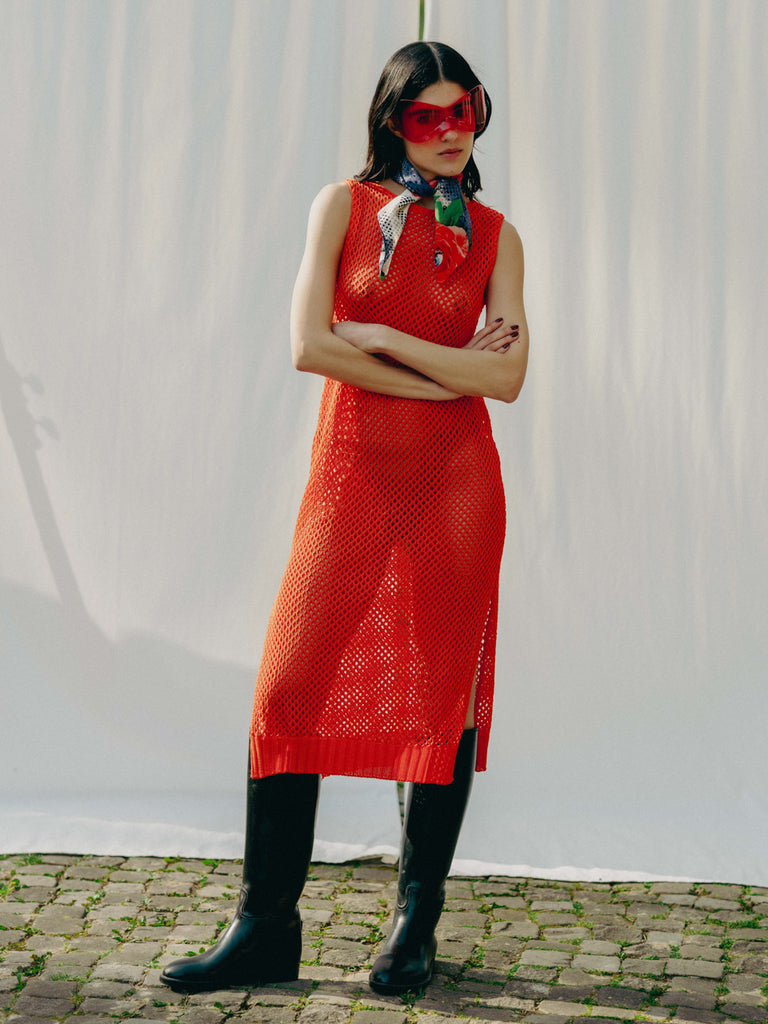 Elegant net knit dress crafted in Switzerland, featuring a classic round neckline, fitting armholes, and stylish side slits, made from organic cotton, perfect for evening wear or summer outings over swimwear.