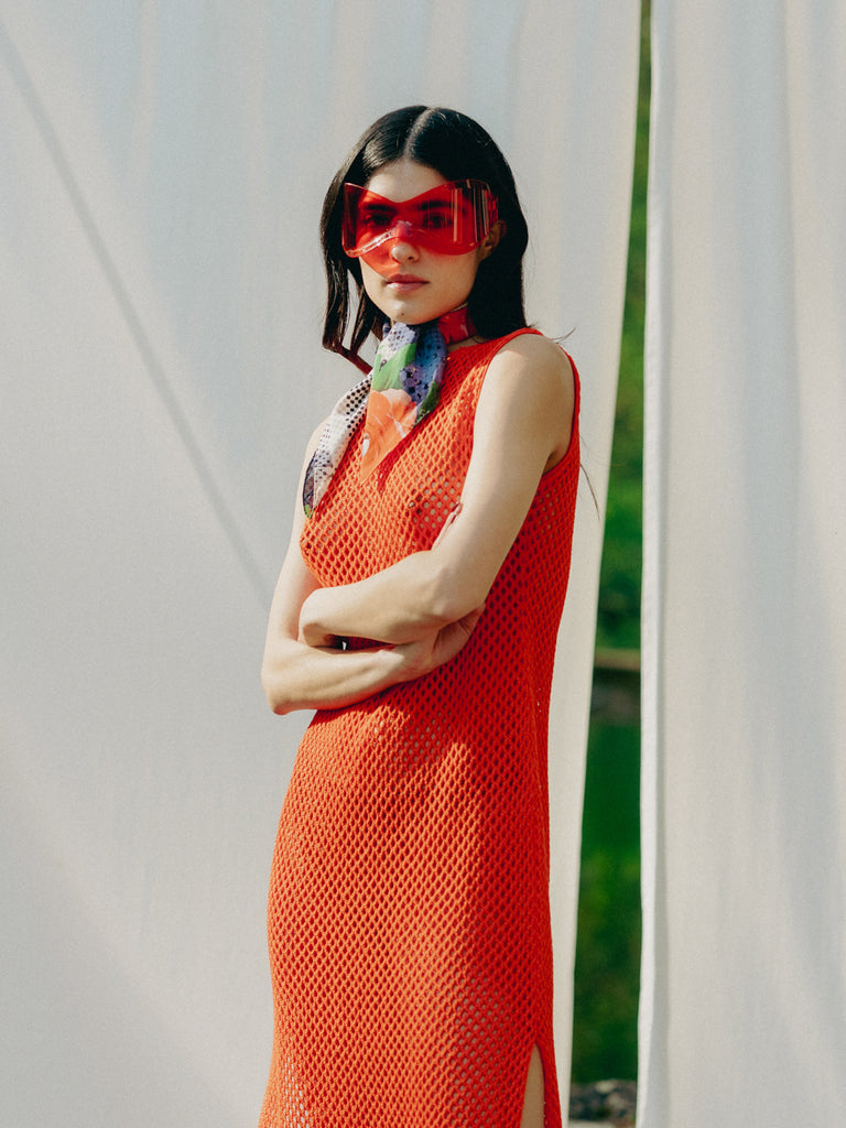 Elegant net knit dress crafted in Switzerland, featuring a classic round neckline, fitting armholes, and stylish side slits, made from organic cotton, perfect for evening wear or summer outings over swimwear.