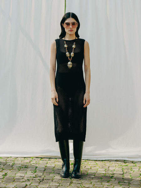 Sassy net knit dress crafted in Switzerland, featuring a classic round neckline, fitting armholes, and stylish side slits, made from organic cotton, perfect for evening wear or summer outings over swimwear