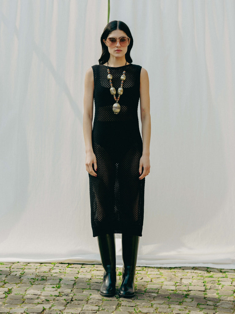 Sassy net knit dress crafted in Switzerland, featuring a classic round neckline, fitting armholes, and stylish side slits, made from organic cotton, perfect for evening wear or summer outings over swimwear