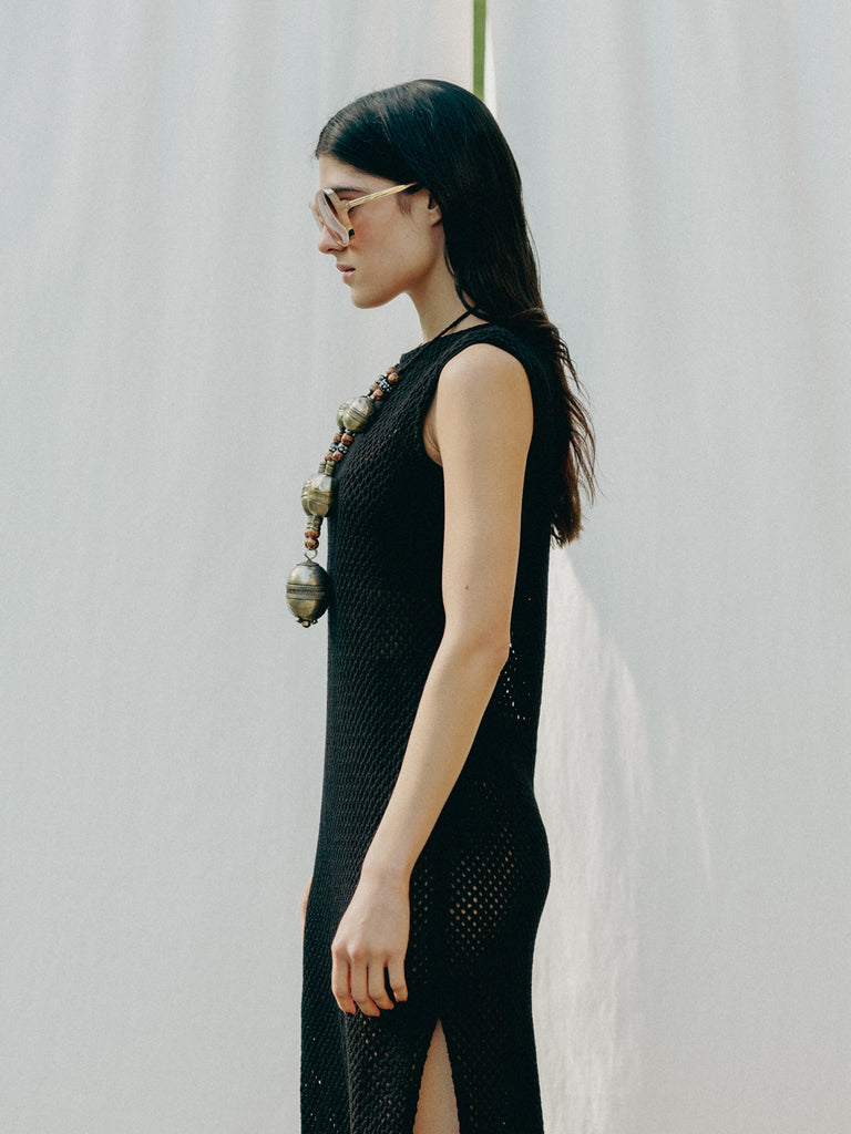 Sassy net knit dress crafted in Switzerland, featuring a classic round neckline, fitting armholes, and stylish side slits, made from organic cotton, perfect for evening wear or summer outings over swimwear