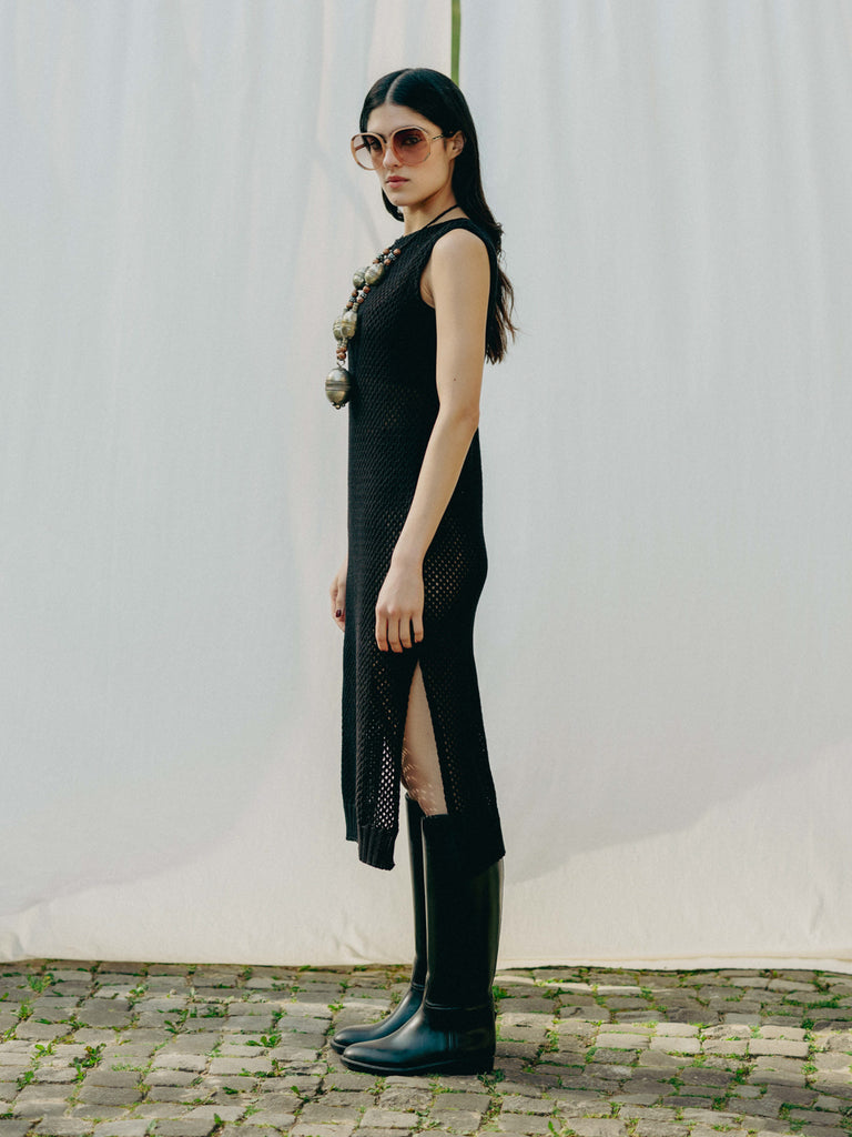 Sassy net knit dress crafted in Switzerland, featuring a classic round neckline, fitting armholes, and stylish side slits, made from organic cotton, perfect for evening wear or summer outings over swimwear