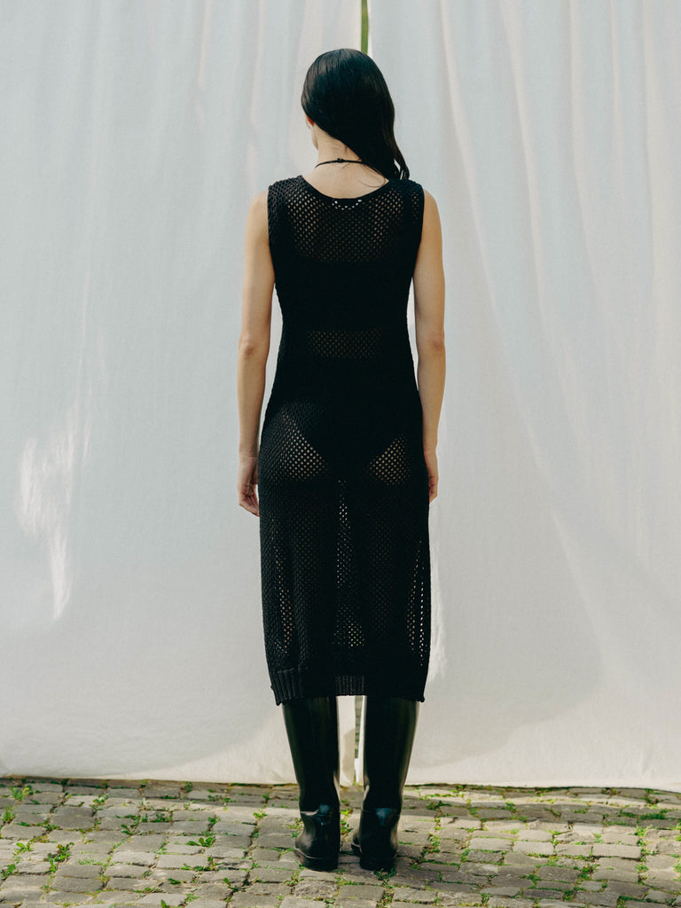 Sassy net knit dress crafted in Switzerland, featuring a classic round neckline, fitting armholes, and stylish side slits, made from organic cotton, perfect for evening wear or summer outings over swimwear