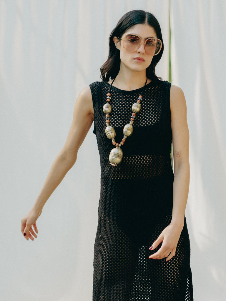 Sassy net knit dress crafted in Switzerland, featuring a classic round neckline, fitting armholes, and stylish side slits, made from organic cotton, perfect for evening wear or summer outings over swimwear