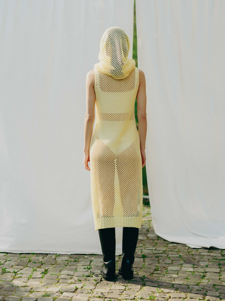 Sassy net knit dress crafted in Switzerland, featuring a classic round neckline, fitting armholes, and stylish side slits, made from organic cotton, perfect for evening wear or summer outings over swimwear