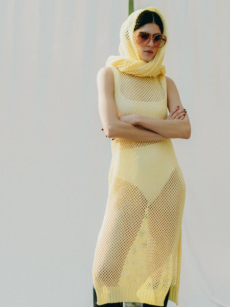 Sassy net knit dress crafted in Switzerland, featuring a classic round neckline, fitting armholes, and stylish side slits, made from organic cotton, perfect for evening wear or summer outings over swimwear