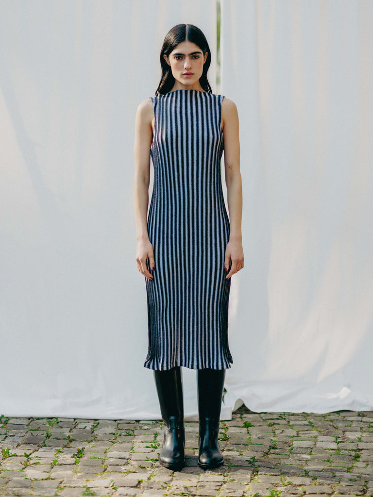 Swiss-made unique rib-knit cotton dress with pleated design, elegant high neckline, and chic side slits, perfect for evening wear or casual style, sustainable and made to order.