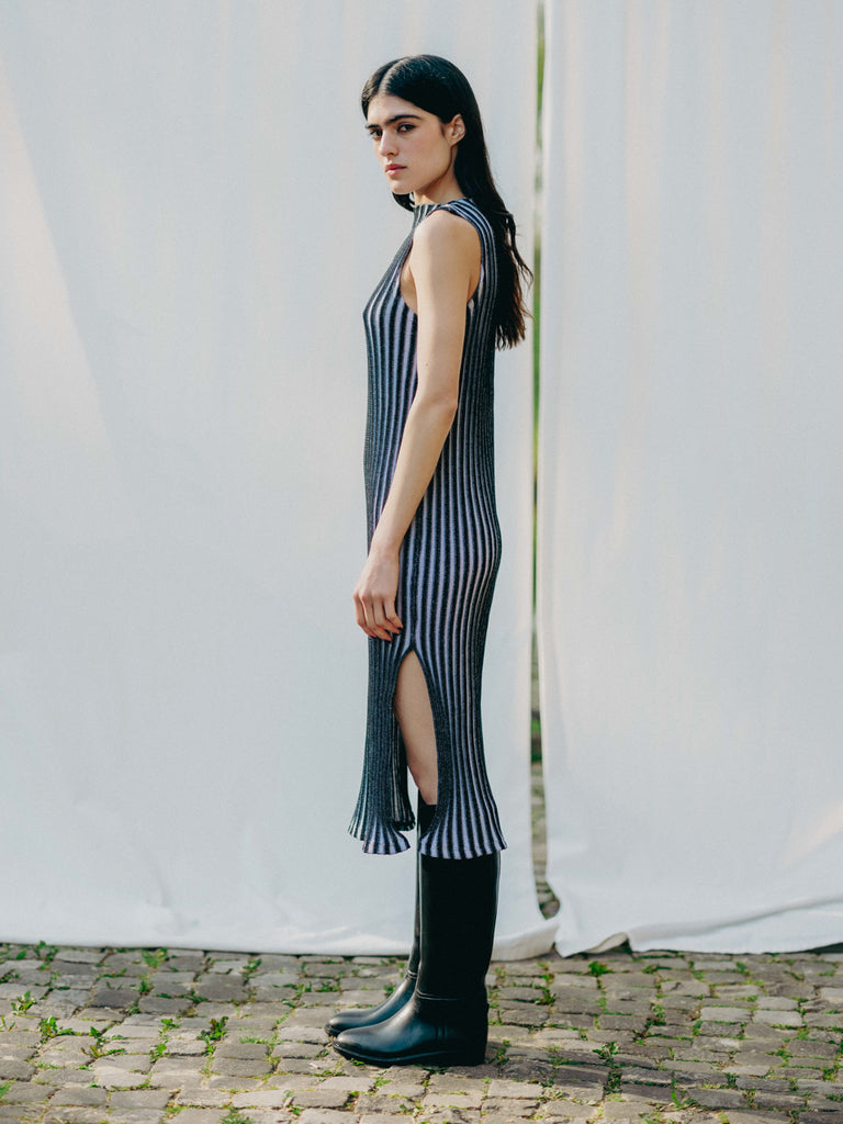 Swiss-made unique rib-knit cotton dress with pleated design, elegant high neckline, and chic side slits, perfect for evening wear or casual style, sustainable and made to order.