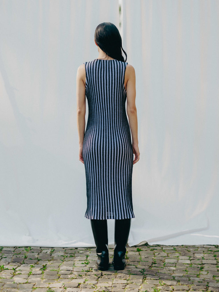 Swiss-made unique rib-knit cotton dress with pleated design, elegant high neckline, and chic side slits, perfect for evening wear or casual style, sustainable and made to order.