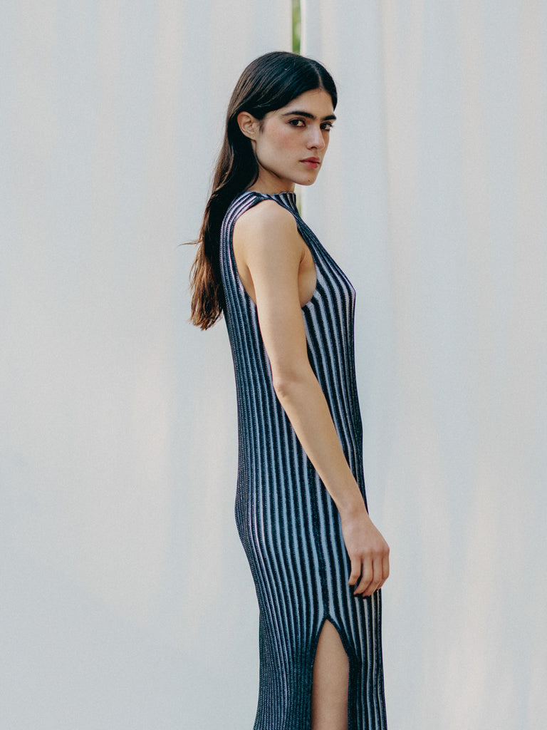 Swiss-made unique rib-knit cotton dress with pleated design, elegant high neckline, and chic side slits, perfect for evening wear or casual style, sustainable and made to order.
