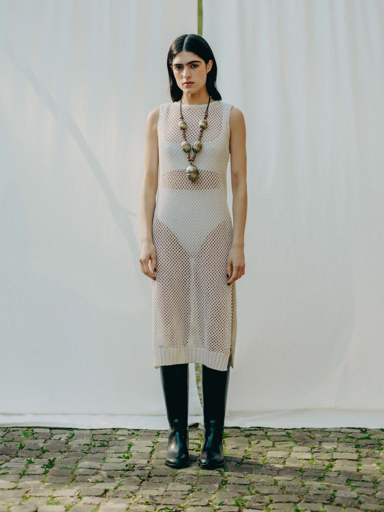 Sassy net knit dress crafted in Switzerland, featuring a classic round neckline, fitting armholes, and stylish side slits, made from organic cotton, perfect for evening wear or summer outings over swimwear