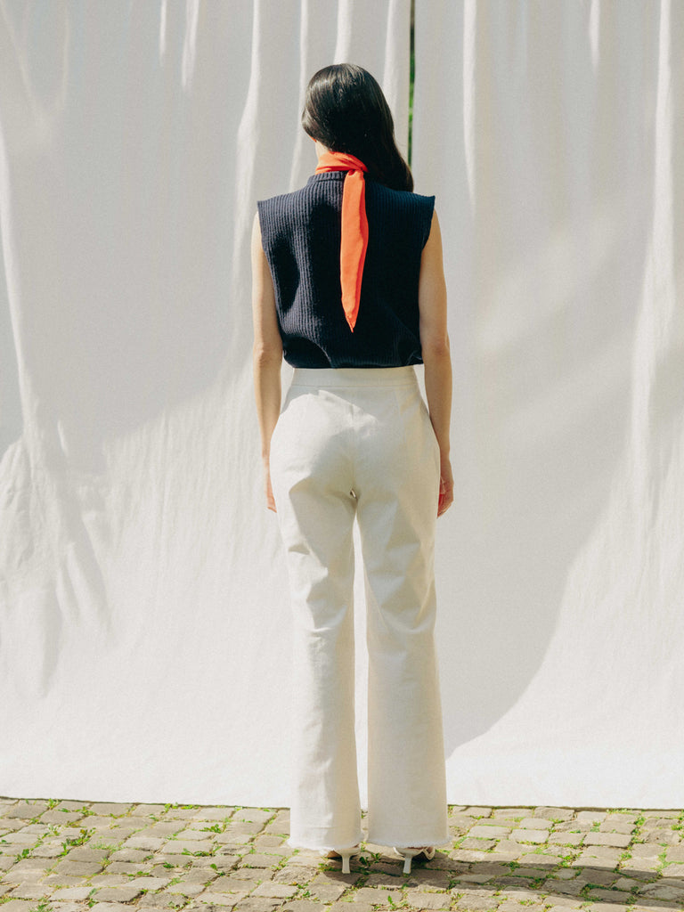 ASTRA: Flared legs, hook closure, handmade fringes. Sustainable, versatile, stylish. GOTS certified.