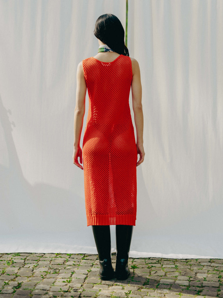 Elegant net knit dress crafted in Switzerland, featuring a classic round neckline, fitting armholes, and stylish side slits, made from organic cotton, perfect for evening wear or summer outings over swimwear.