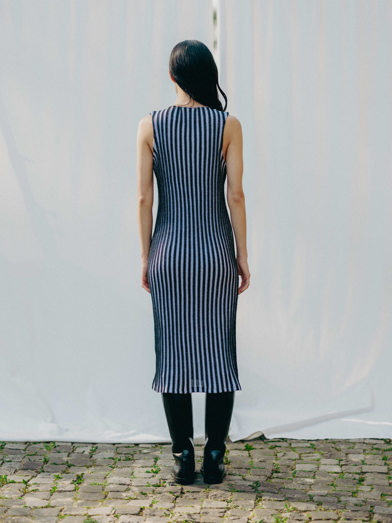 Swiss-made unique rib-knit cotton dress with pleated design, elegant high neckline, and chic side slits, perfect for evening wear or casual style, sustainable and made to order.